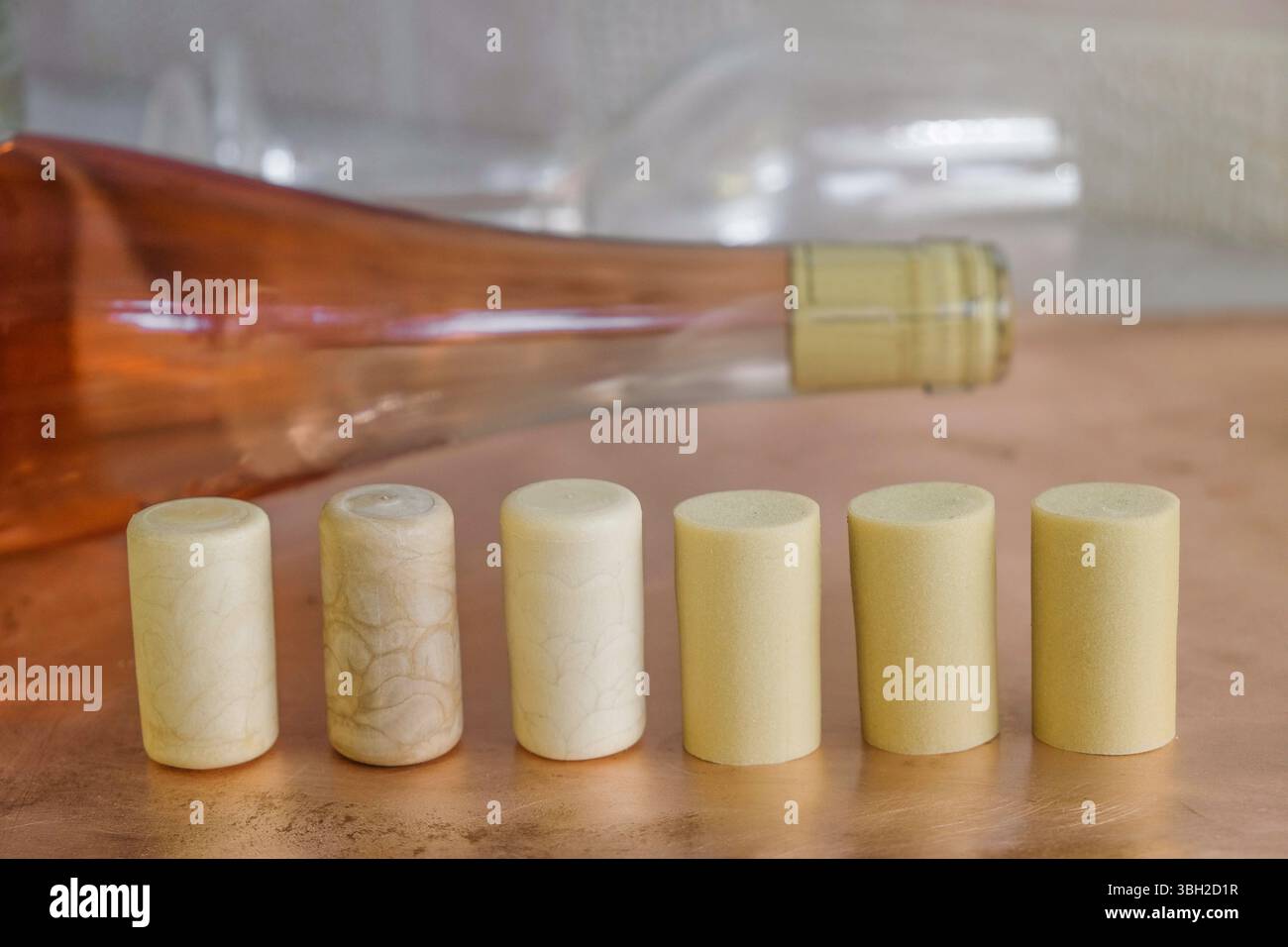 Synthetische Weinkorken auf dem Hintergrund einer Korkflasche Rosenwein. Stockfoto