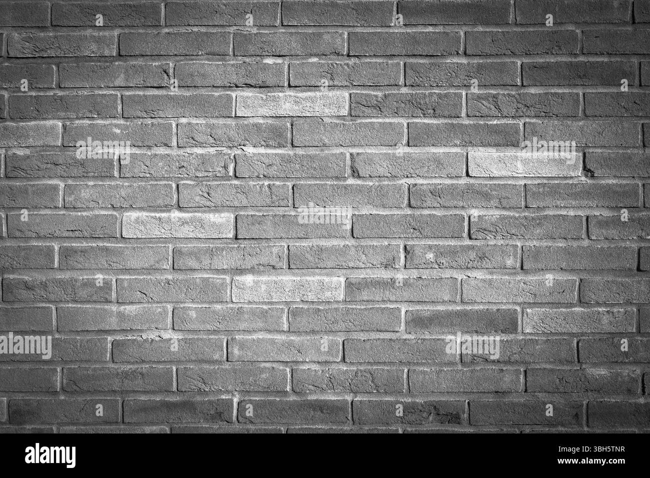 Schwarz-weißer Hintergrund einer gemauerten Mauer Stockfoto