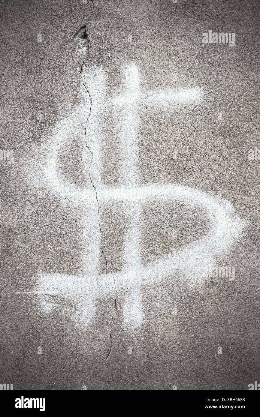 Dollarschild mit Rissen an der Wand. Finanzkrisenkonzept Stockfoto