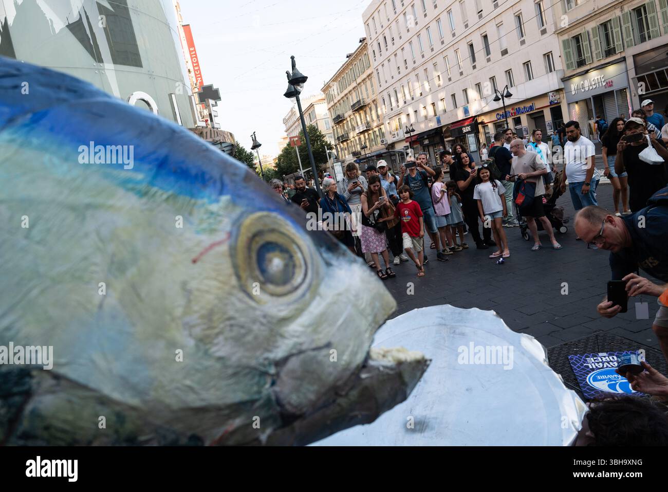 Nizza, England, Frankreich. Juni 2025. Am Welttag der Ozeane veranstalteten Aktivisten der Ocean Rebellion einen theatralischen Protest vor einem Monoprix-Supermarkt in Nizza, Frankreich, um die Bedenken hinsichtlich der industriellen Thunfischfangpraxis zu beleuchten. Die Demonstration zeigte Künstler, die eine riesige Dose Petit Navire Thunfisch mit einem˜toten Seemann enthüllten, begleitet von einer satirischen Darbietung des französischen Liedes˜Il Ã Tait un Petit Navire. Mit dem Protest sollte auf angebliche Menschenrechtsverletzungen und Umweltauswirkungen im Zusammenhang mit der Thunfischfischerei, insbesondere im Zusammenhang mit der Marine Stewardship, hingewiesen werden Stockfoto