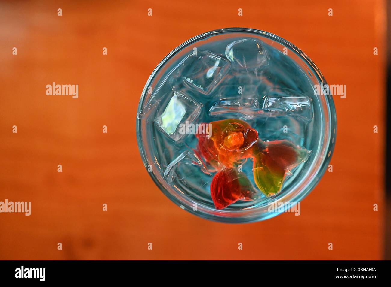 Künstlerische Inspiration für Drinks, orange schwimmende Goldfische in kristallgrünen Cocktails Stockfoto