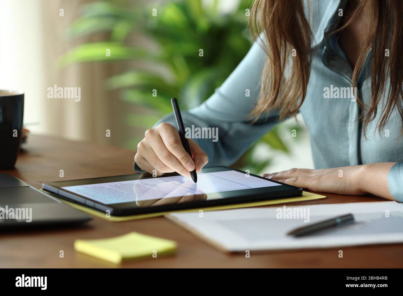 Nahaufnahme eines Mitarbeiters, der im Büro Handschriften auf einem digitalen Tablet abgibt Stockfoto