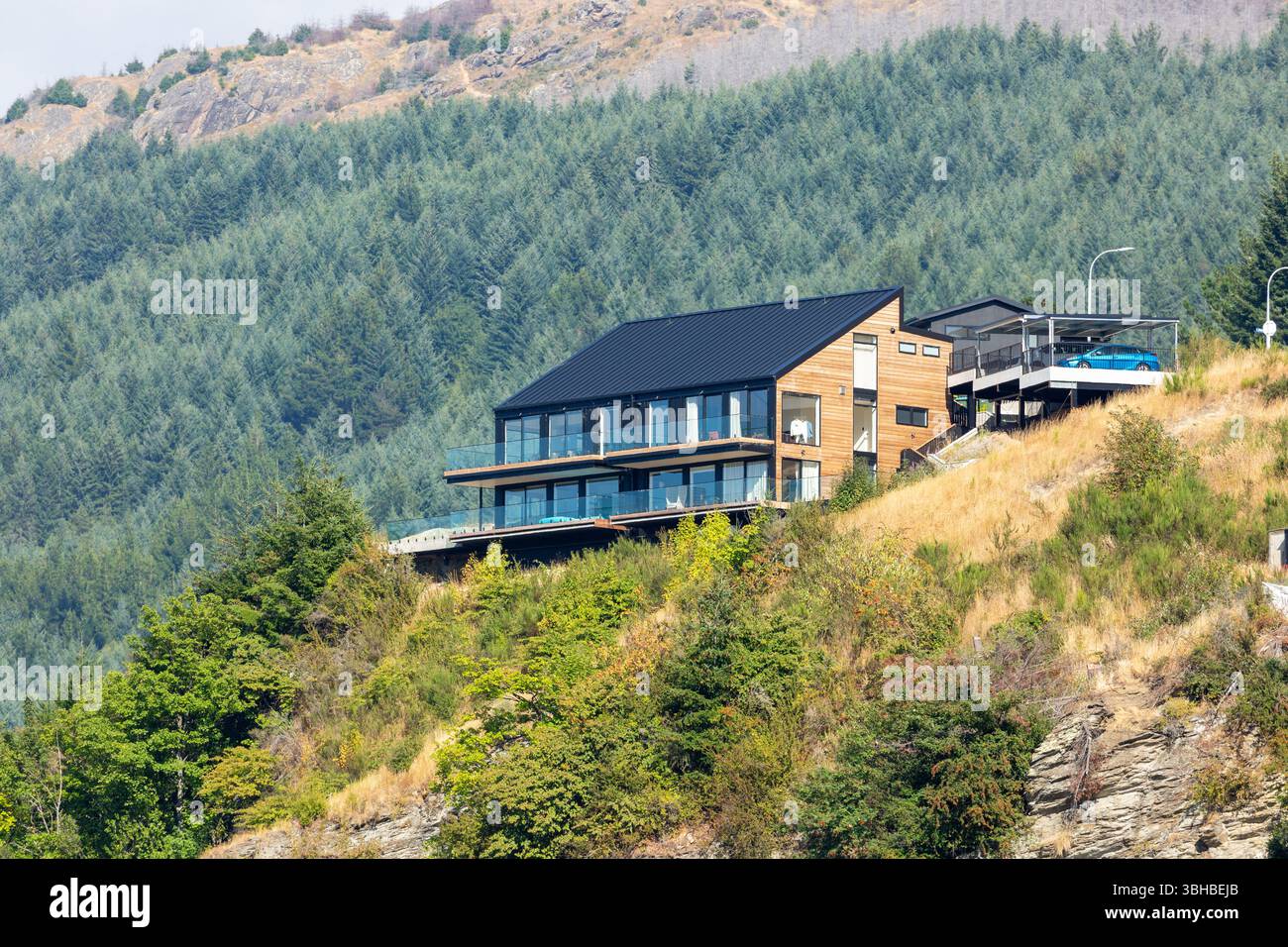 Modernes Haus am See auf dem Hügel mit Blick auf Lake Wakatipu, Queenstown, Otago, Neuseeland Stockfoto
