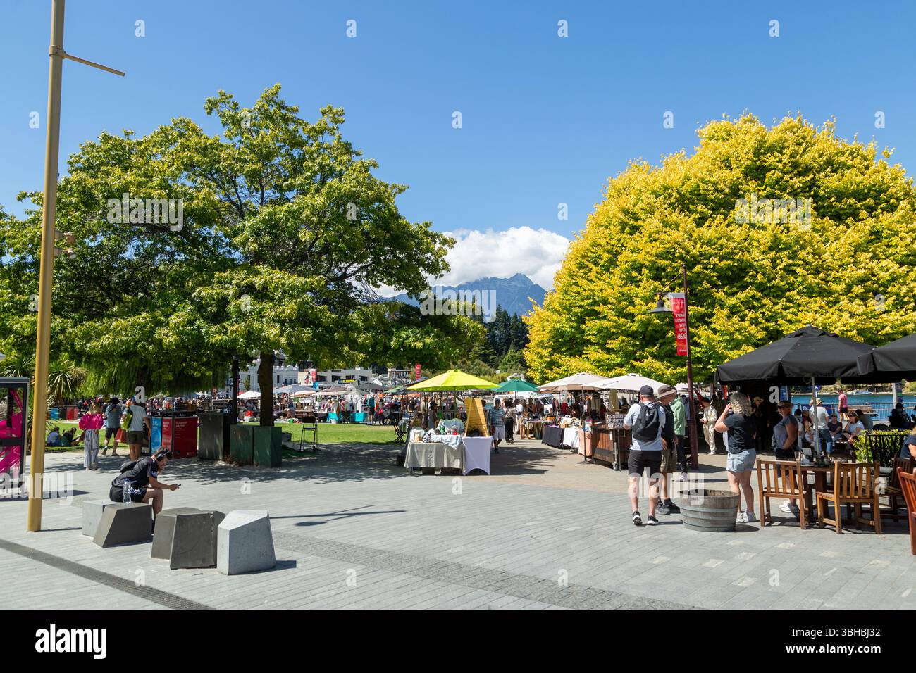 Menschen genießen die Sonne im Earnslaw Park Queenstown, Otago, Neuseeland Stockfoto