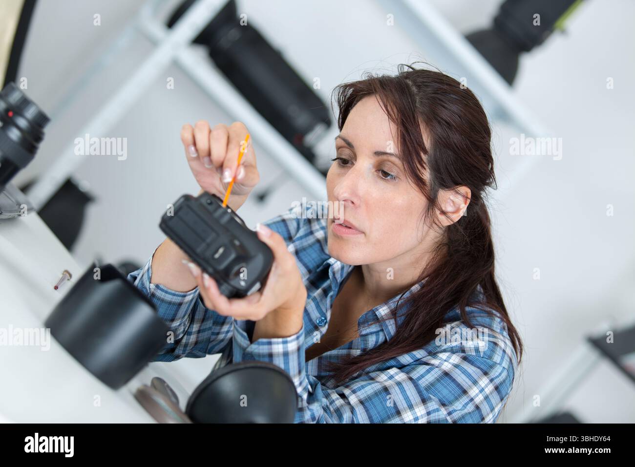 Porträt der Frau während der Kamerareparatur Stockfoto