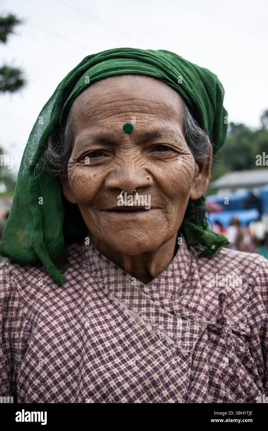 Eine hügelige Frau trägt eine Bulaki, eine goldene Nasennadel oder Nasendangler, die durch das Septum bis zur Unterlippe durchbohrt. Sankhuwasabha, Nepal. Stockfoto