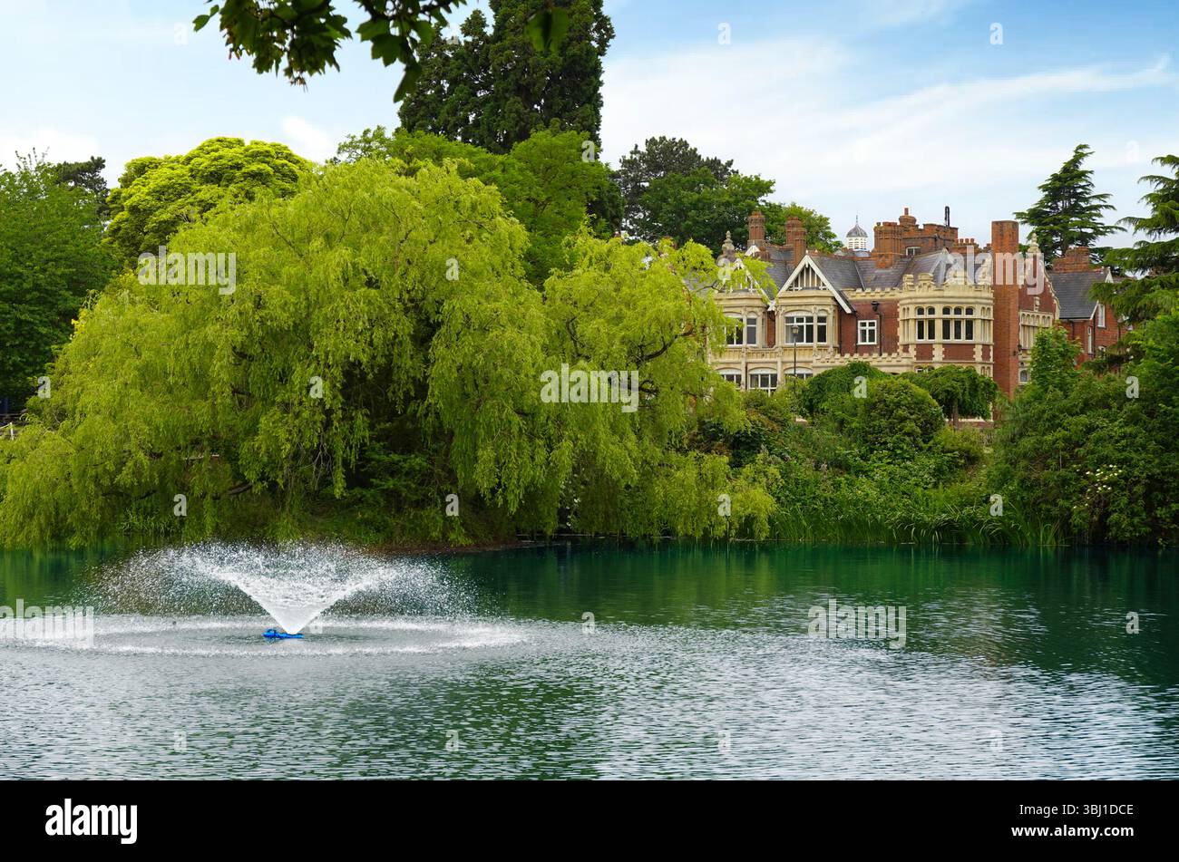 Mit Blick über den See und den Brunnen zum Herrenhaus, einem viktorianischen Gebäude im Bletchley Park Museum und Kulturerbe-Attraktion in der Nähe von Milton Keynes, England, Großbritannien Stockfoto