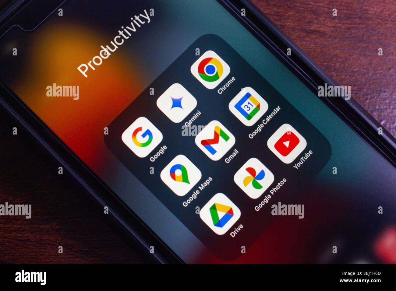 Smartphone-Bildschirm mit Google-gebündelten Apps (Google, Gemini, Chrome, Google Maps, Gmail, Google Calendar, Drive, Google Photos und YouTube). Stockfoto