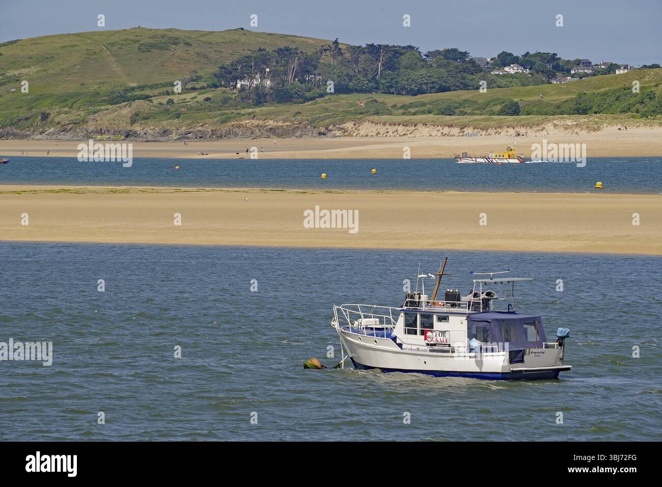 Motorboot auf ruhigem Wasser in der Nähe einer grünen Küste mit Hügeln im Hintergrund, Camel Trail, Padstow, Cornwall, Cornwall, England, Vereinigtes Königreich, Europa Stockfoto