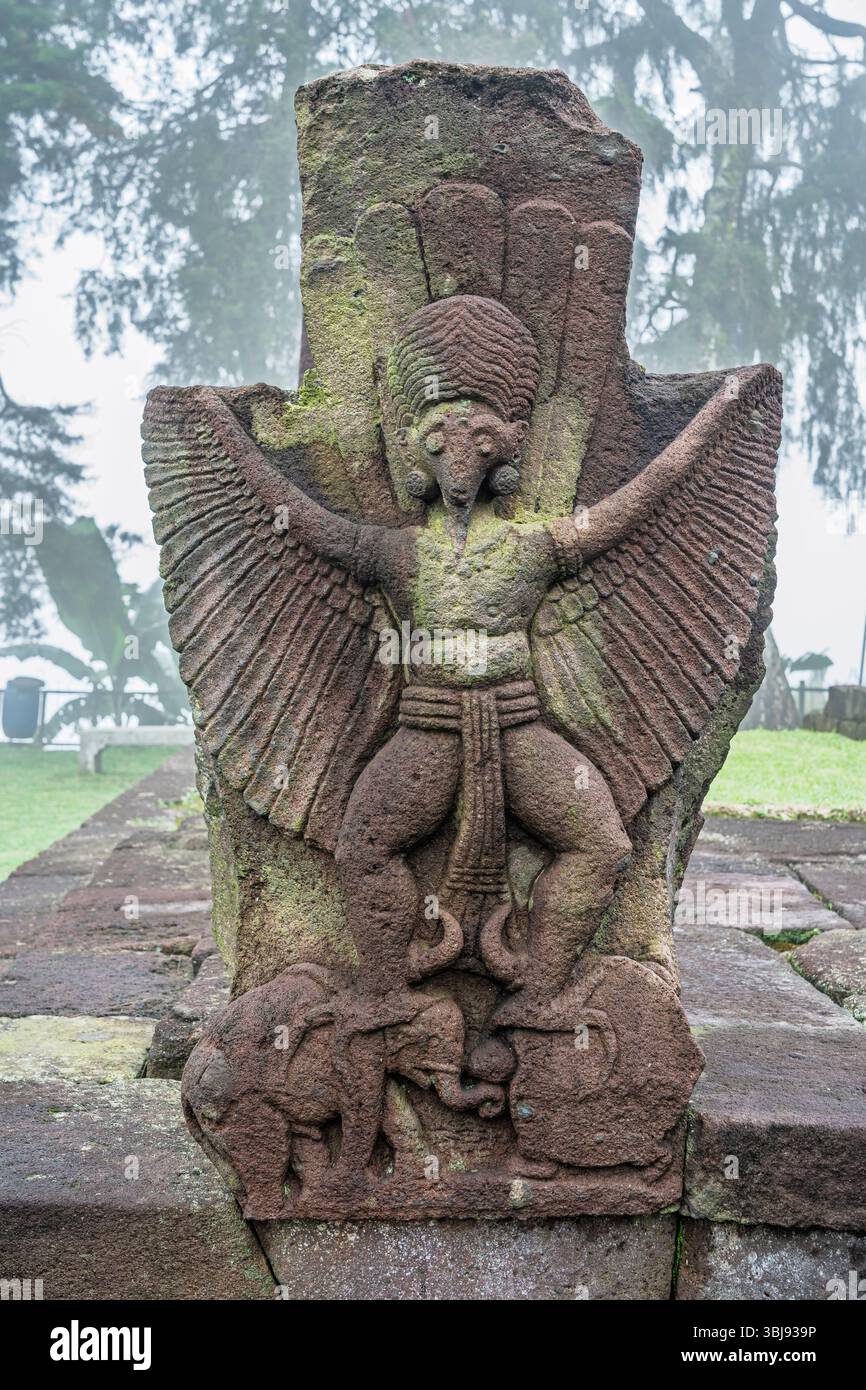 Vertikale Nahaufnahme der Garuda-Steinschnitzerei im alten Candi Sukuh hindu-Tempel am nebeligen Morgen, Karanganyar, Zentral-Java, Indonesien Stockfoto