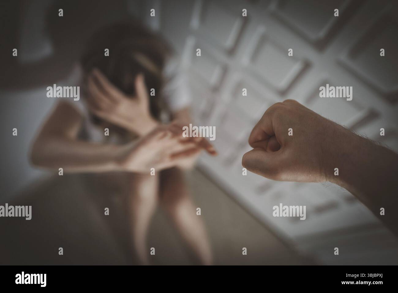 Mann schlaegt die Frau mit der Faust. Opfer von häuslicher Gewalt Stockfoto