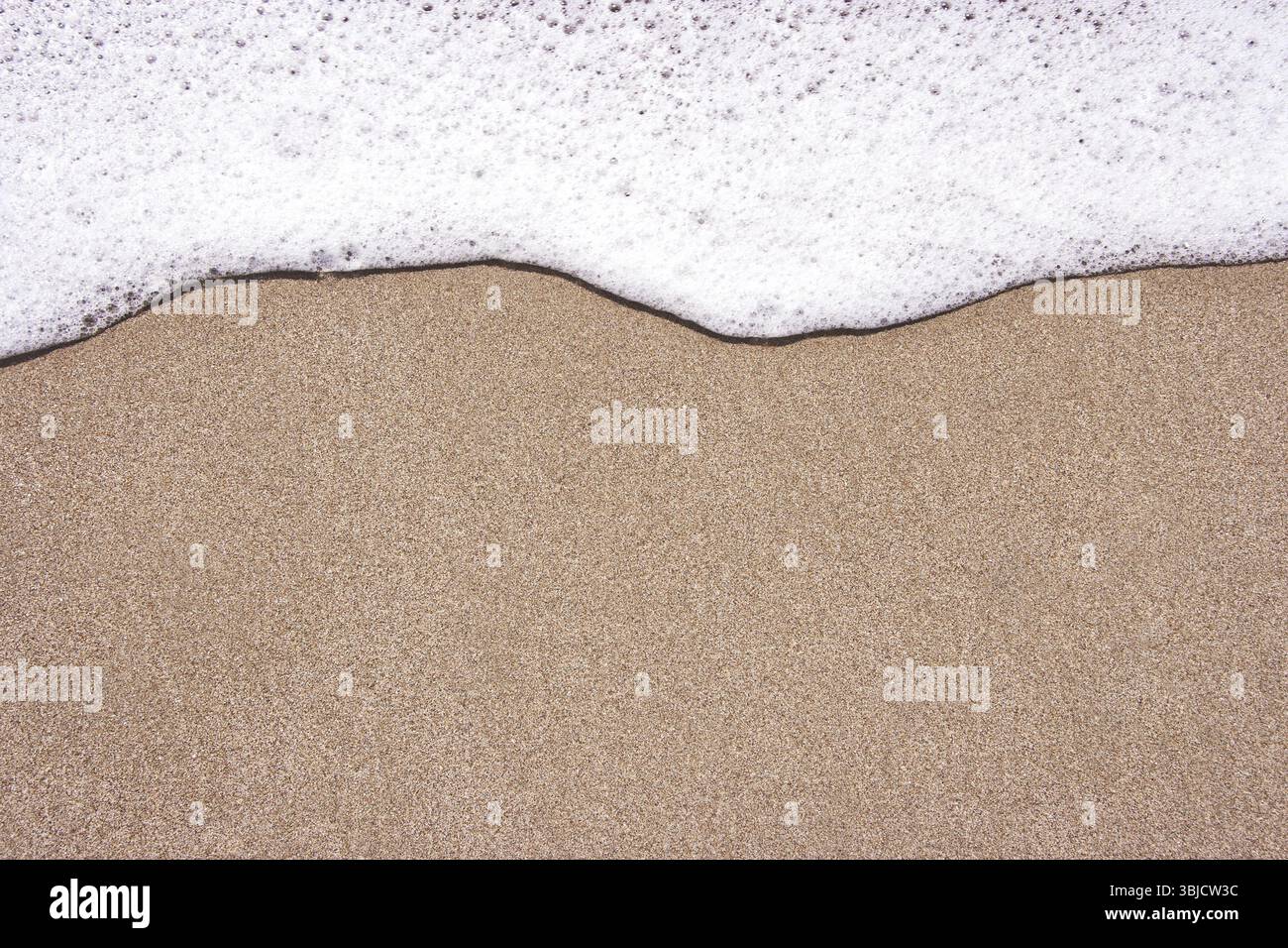 Strand Hintergrund an einem sonnigen Tag. Wellen- und Sandrand Stockfoto
