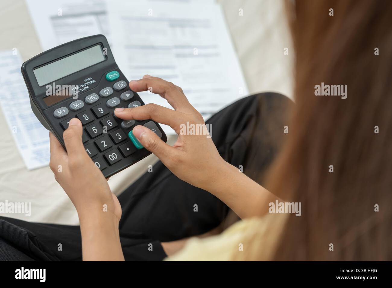 Gestresste und Kopfschmerzen Frau mit großen Rechnungen oder Rechnungen, kein Geld für Ausgaben und Kreditkartenschulden. Knappheit, Finanzproblem, Konkurs, Mo Stockfoto
