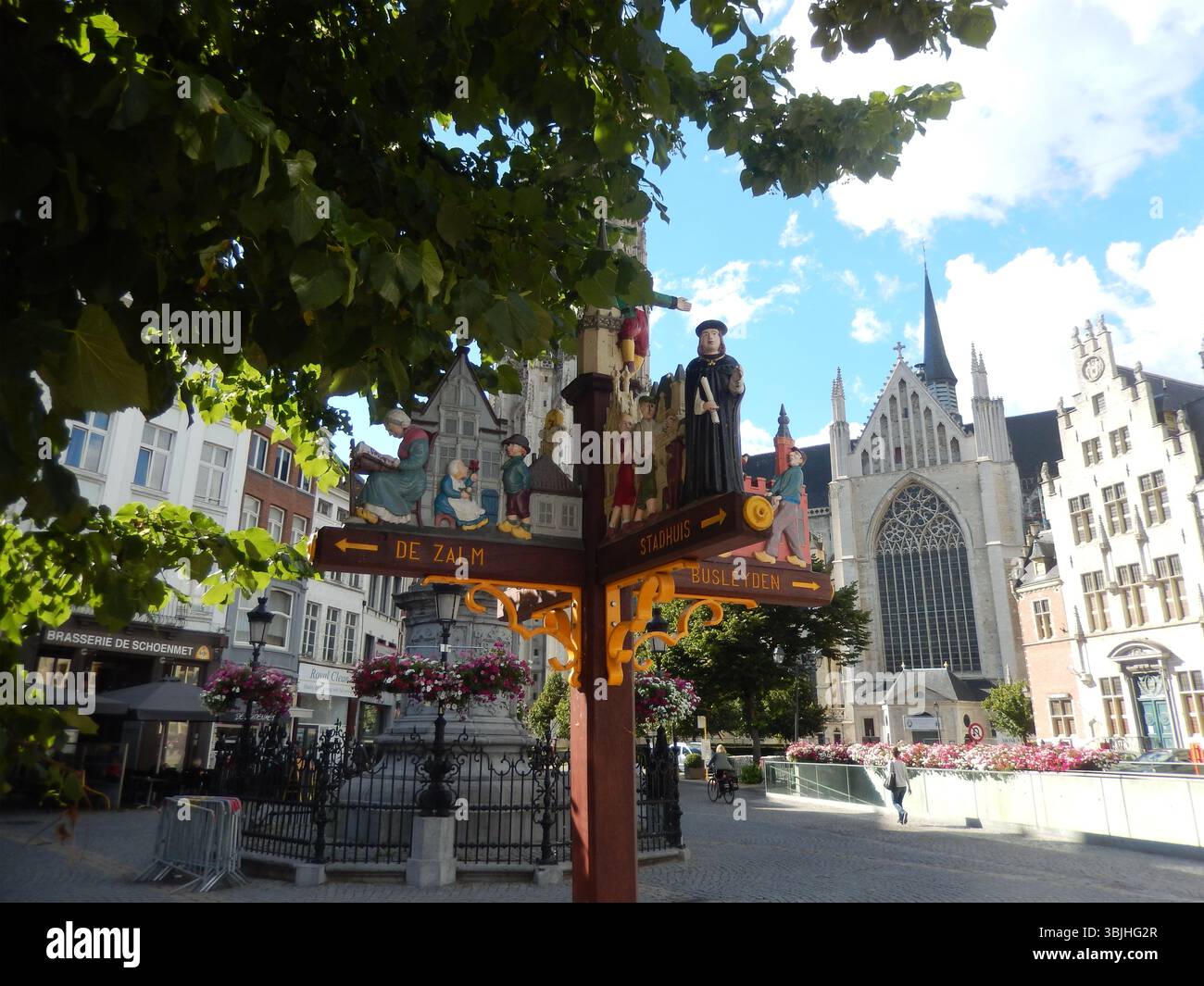 Dekorativer Wegweiser am historischen Europäischen Platz mit malerischem Blick auf die Kirche. Mechelen, Belgien Stockfoto