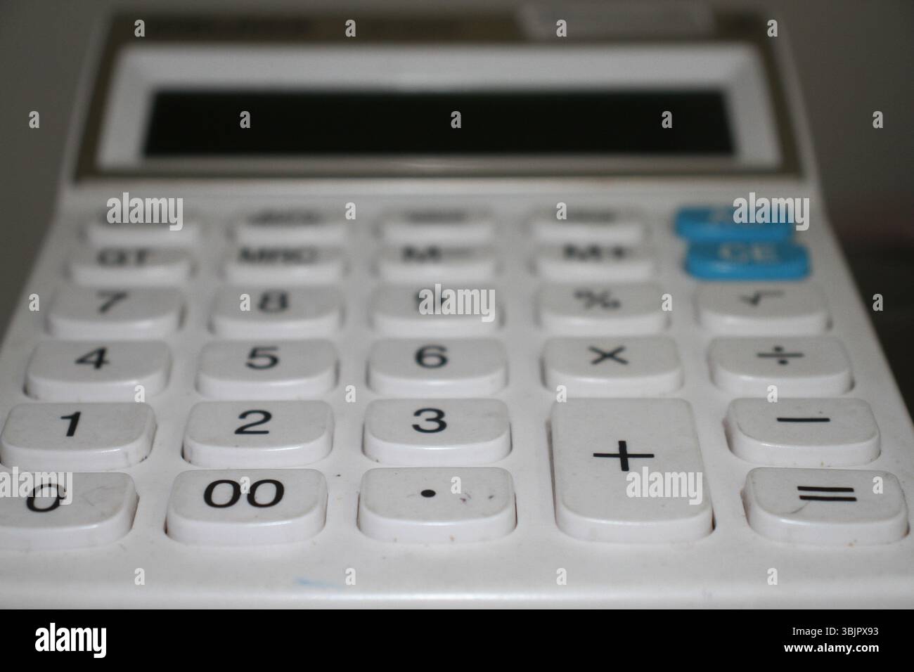 Ein weißer Taschenrechner wurde für Effizienz und Klarheit entwickelt. Dank seines übersichtlichen Layouts und des leicht ablesbaren Displays ist er ideal für das Büro und zu Hause. Stockfoto