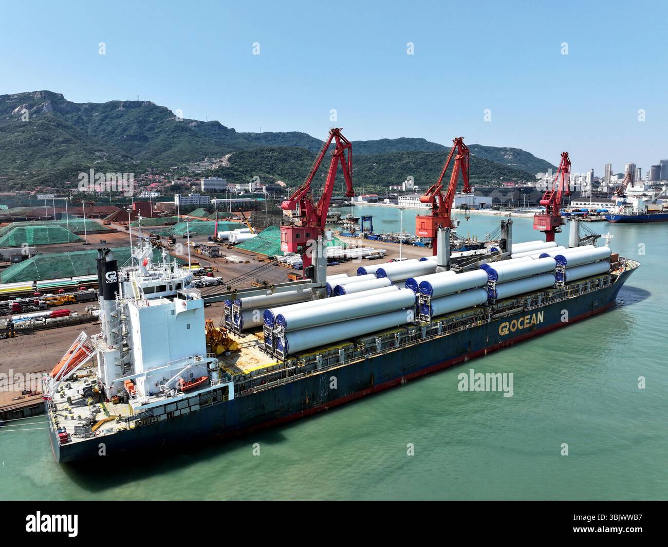 Ein Seeschiff lädt Windkraftanlagen für den Export ins Ausland in der Stadt Lianyungang, Provinz Jiangsu, China am 17. Juni 2025. Stockfoto