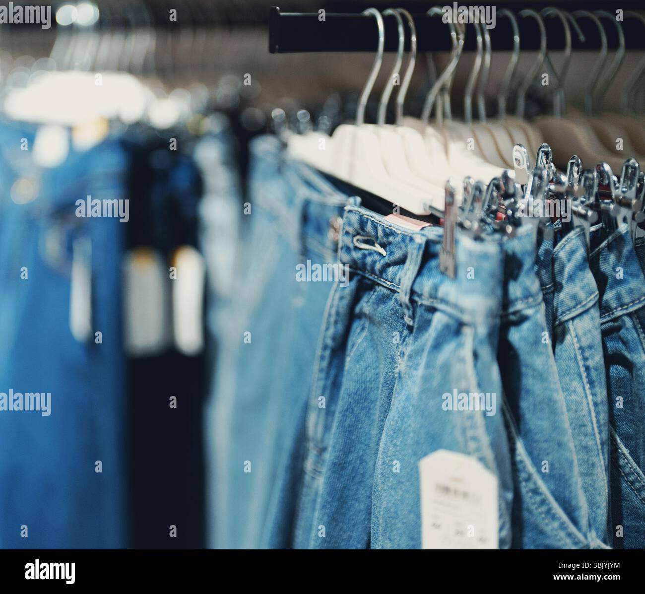 Regal mit Jeans im Bekleidungsgeschäft. Stockfoto