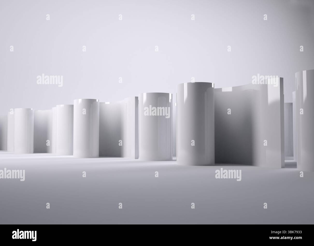 Mit glänzend weißen Zylindern, die sich in einem flachen Design-Studio unter weichem Licht mit verlaufendem Hintergrund erheben Stockfoto