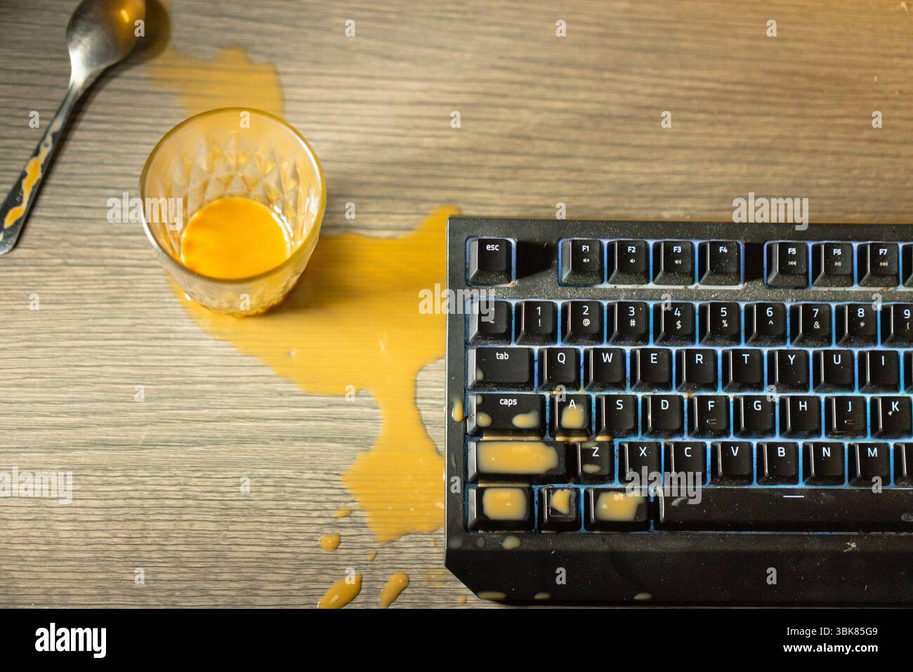Kaffee ist auf die mechanische Tastatur der Computernähe verschüttet Stockfoto