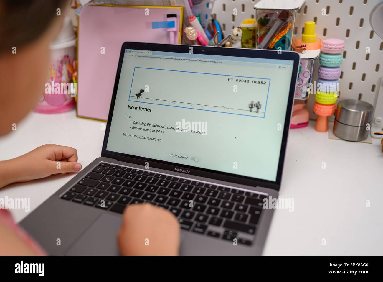 Antalya, Türkei - 17. Juni 2025: Mädchen spielt Chrome Dino Laufspiel Stockfoto