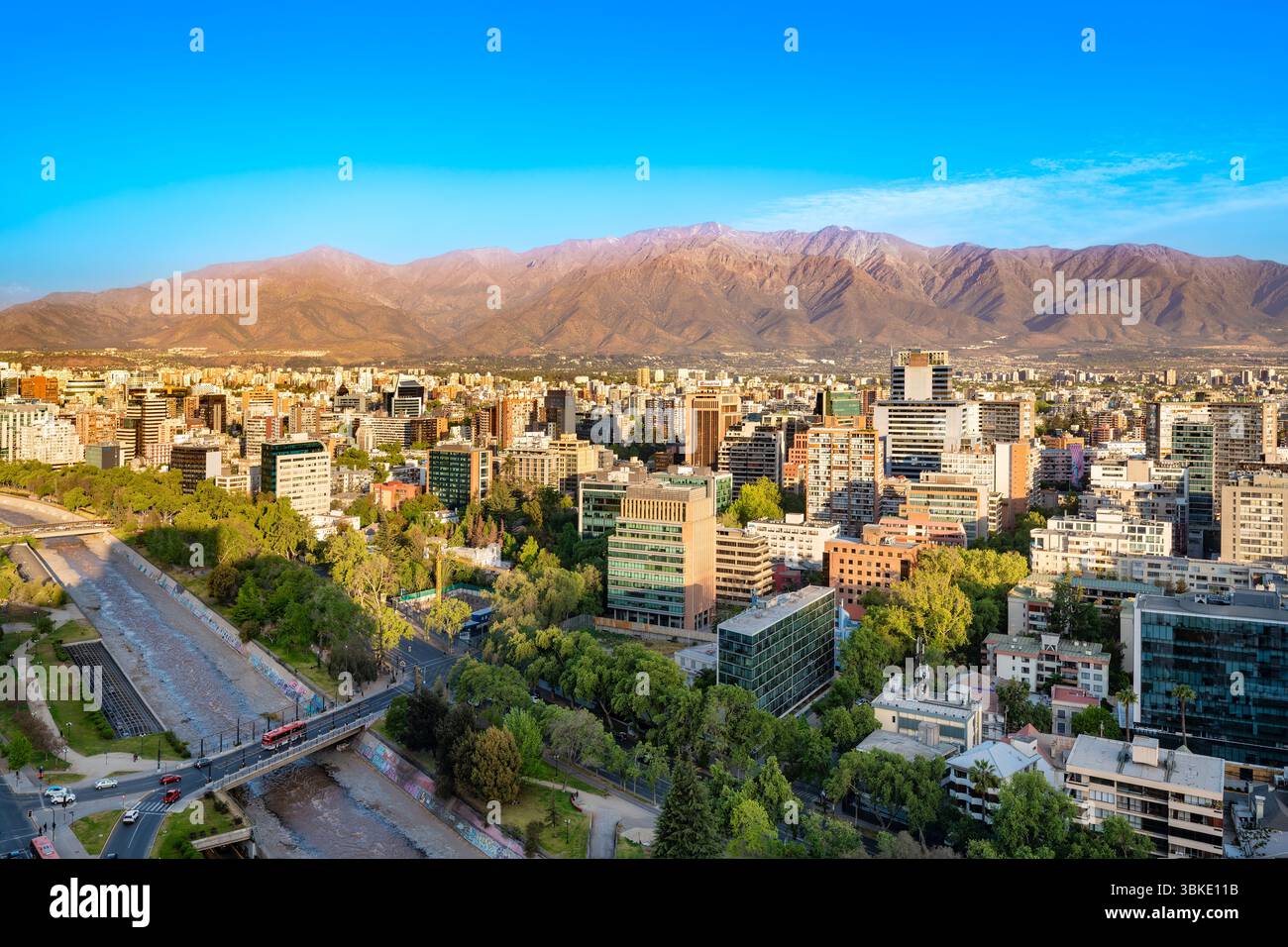 Santiago, Chile - die Gebäude von Providencia säumen den Mapocho River, alle im Sommer vor der atemberaubenden Kulisse der Anden. Stockfoto