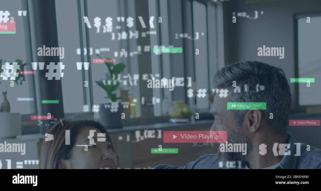 Bärtige Mann und Frau in lässiger Kleidung, die Code-Snippets in modernen Büros überprüfen, mit Pflanzen Stockfoto