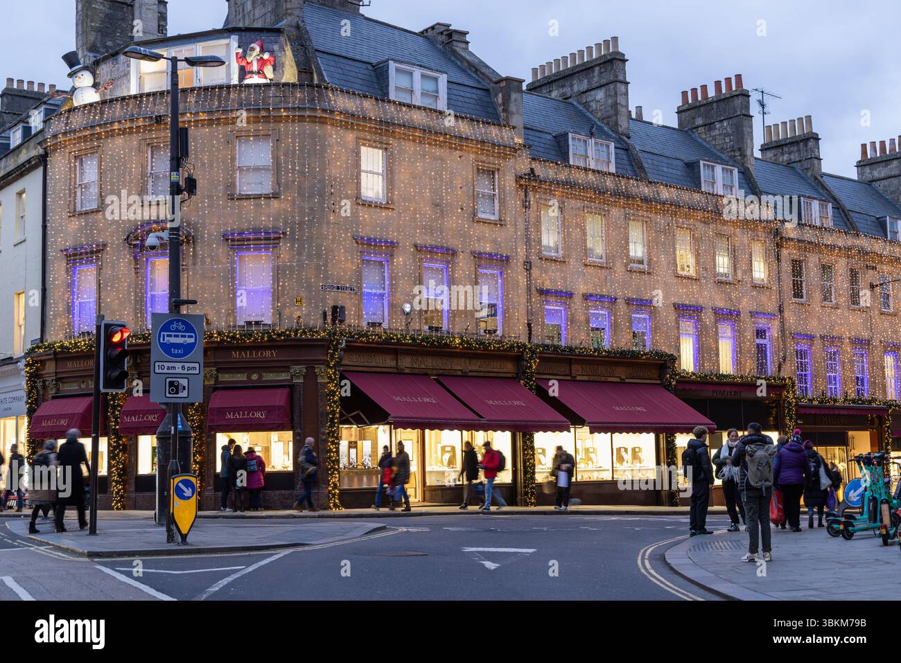 Mallory, der älteste Juwelier in Bath, beleuchtet mit Weihnachtslichtern in der Abenddämmerung. Bath Christmas Market, City of Bath, BANES, England, Großbritannien Stockfoto