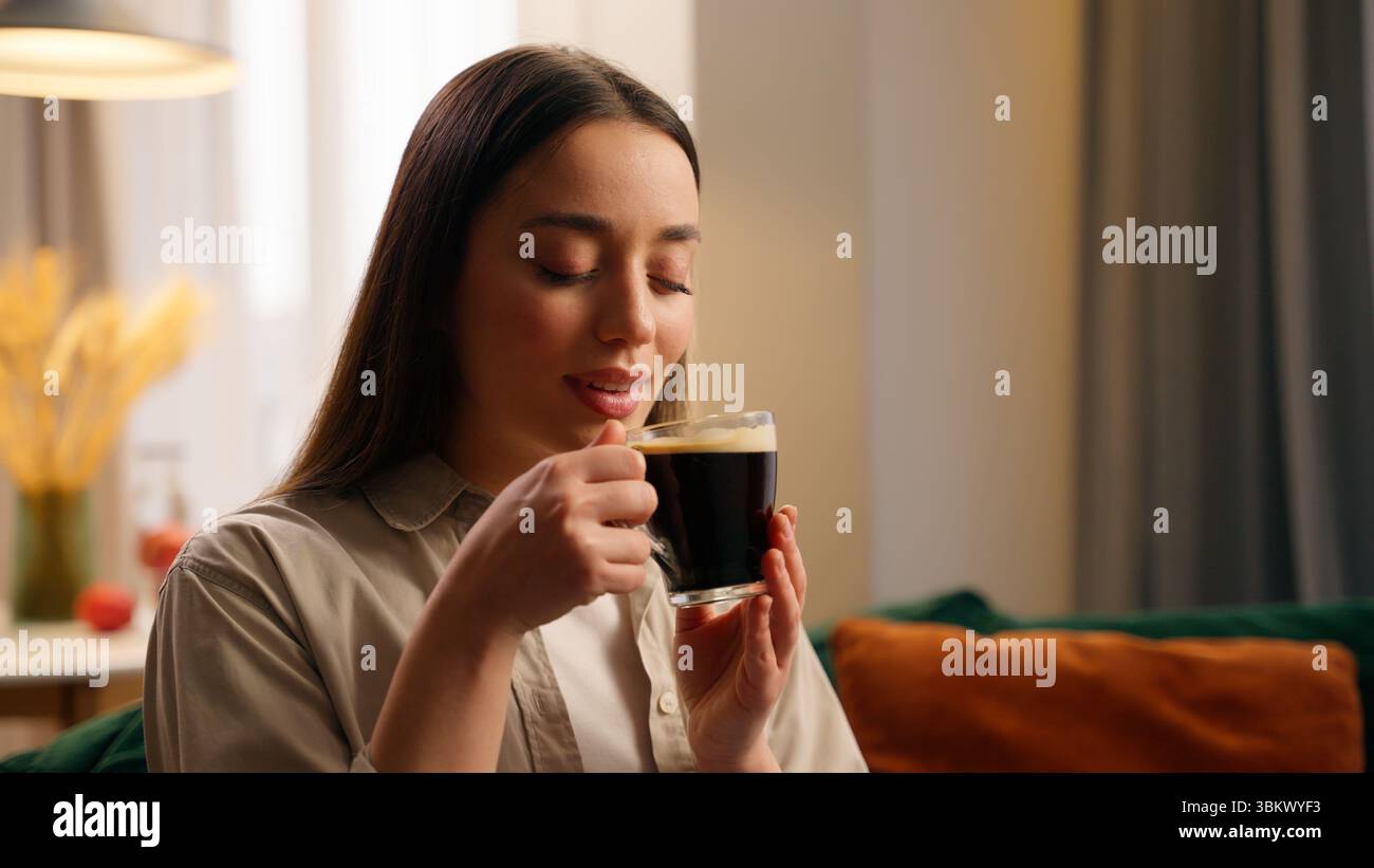Kaukasische Frau weibliches Mädchen inhalieren angenehmes Aroma von dunklem Kaffee Tee schnüffeln genießen Geruch von Getränk halten Tasse lächelnd schnüffeln aromatisch riechen Stockfoto