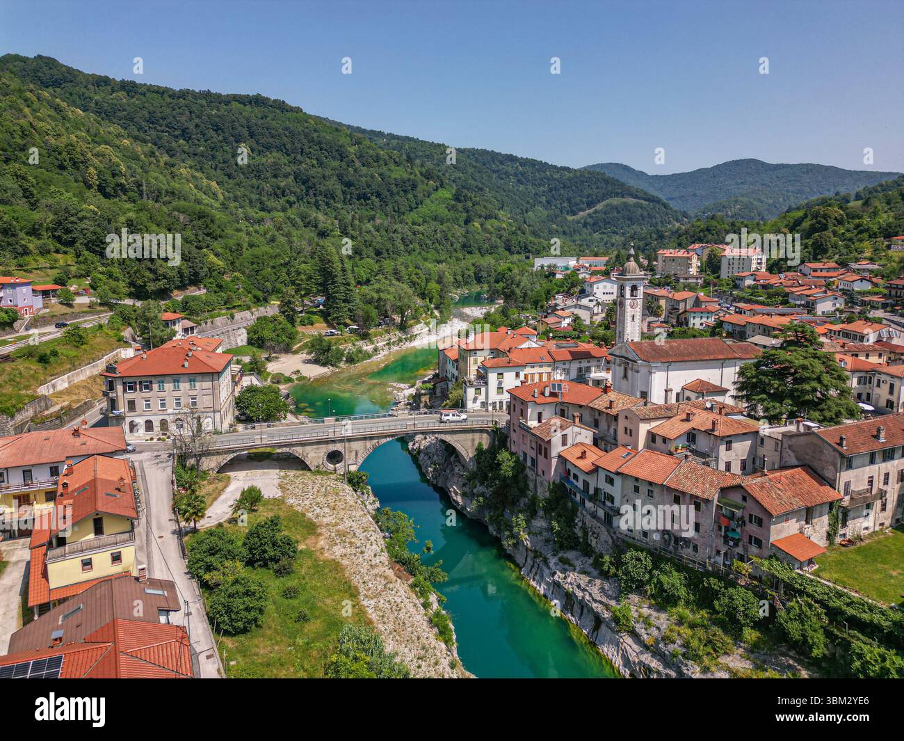 Blick von der Drohne auf eine malerische und idyllische mittelalterliche Stadt Kanal ob Soči. Steinbrücke über den smaragdgrünen Fluss. Soča-Tal, Slowenien Stockfoto