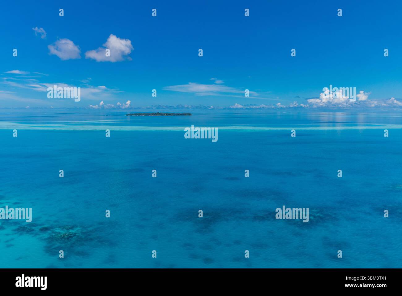 Blick auf den tropischen Ozean mit Korallenriff Lagune und Bucht, ruhige Meereslandschaft mit klarem blauem Wasser, friedliche Sommerküste Natur Hintergrund Meerespar Stockfoto