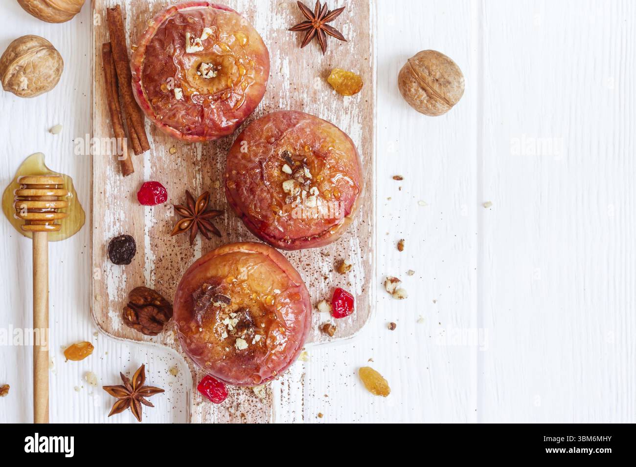 Rote gebackene Äpfel mit Zimt, Walnüssen und Honig. Dessert im Herbst oder Winter Stockfoto