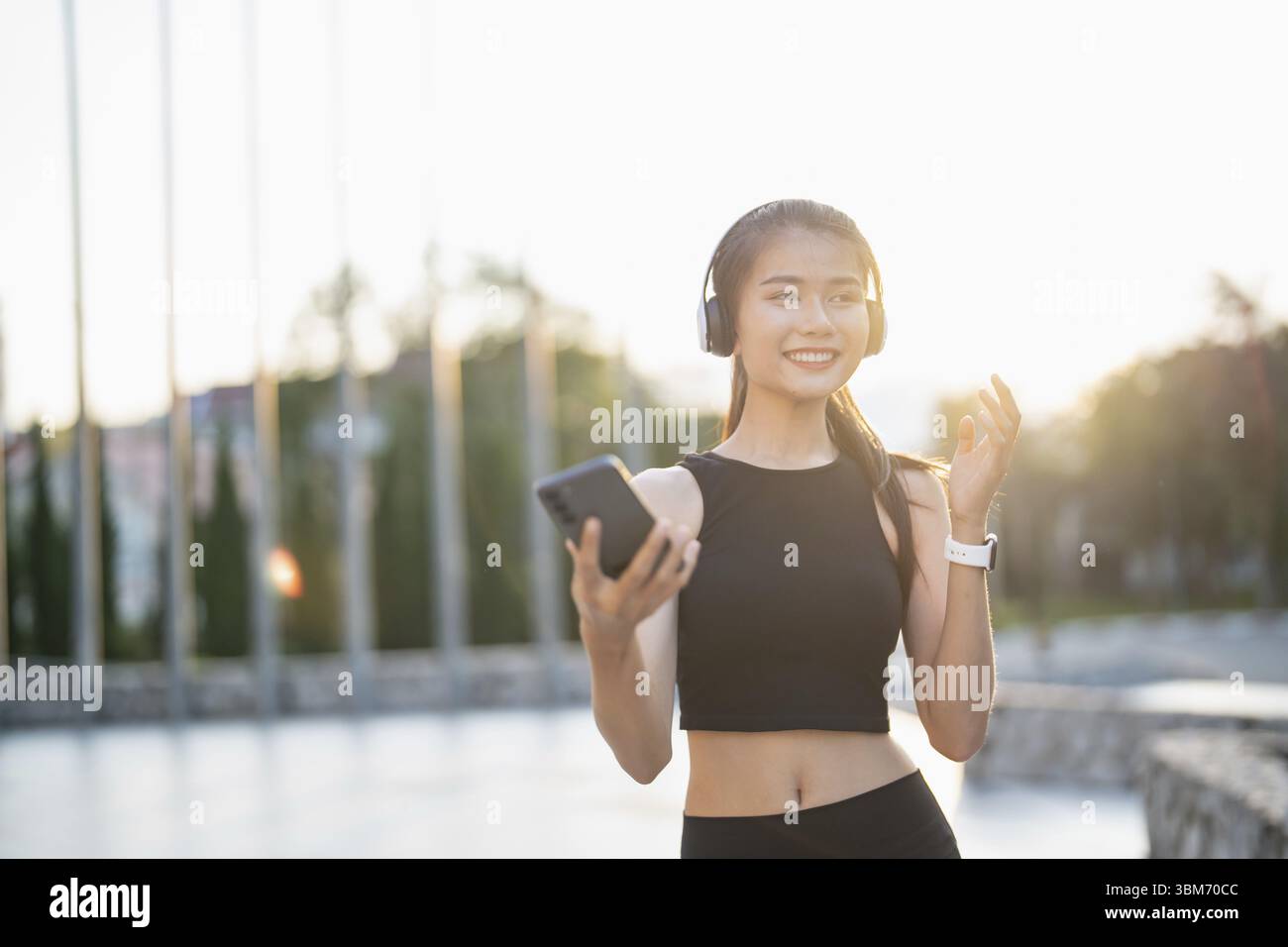 Happy Active Healthy asian Woman hört Musik mit Kopfhörern für geistige Gesundheit Hören von Audio für Laufen Inspiration Stockfoto