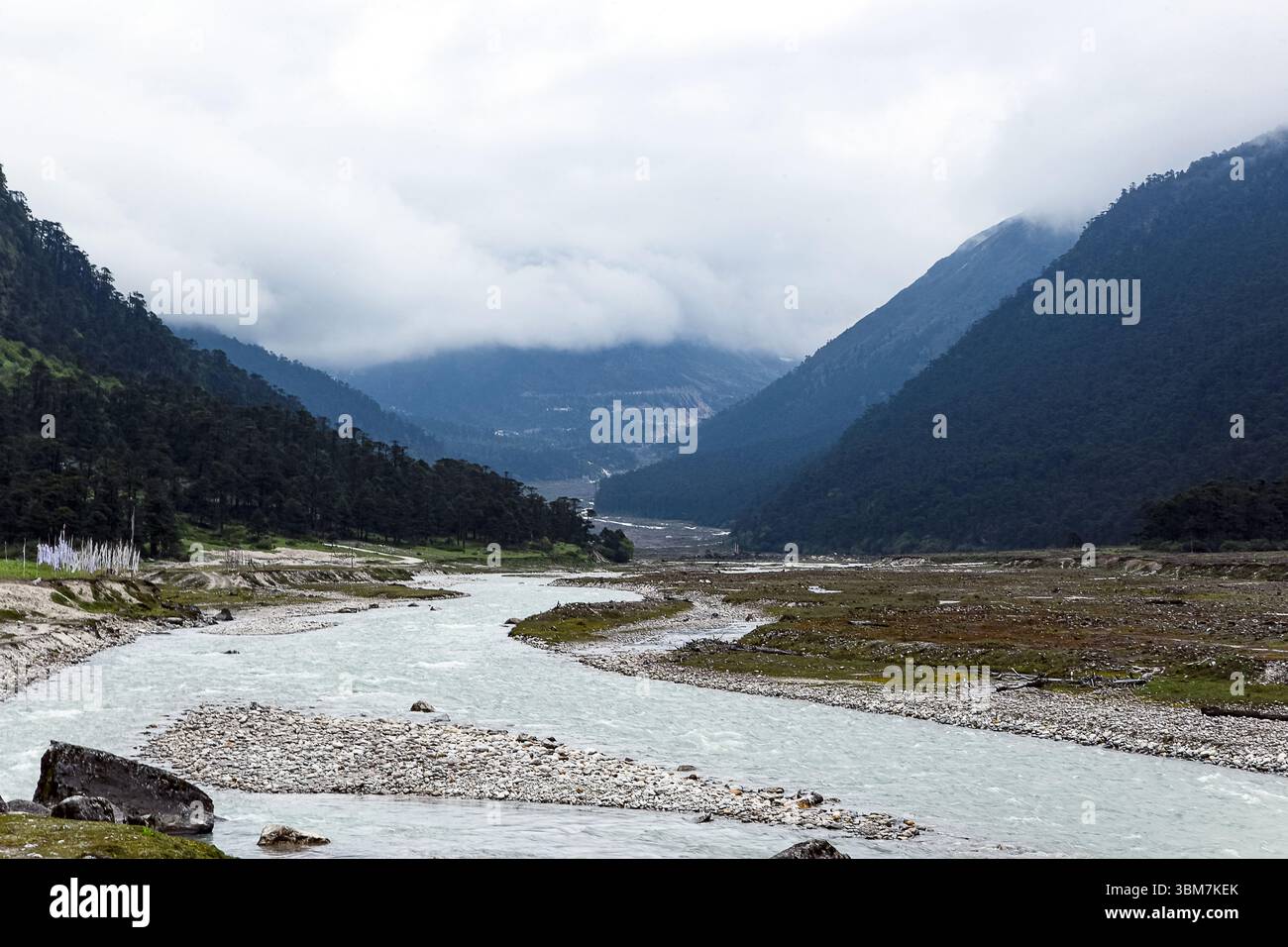 Ein atemberaubender Blick auf das Yumthang Valley in North Sikkim, Indien, mit einem unberührten Bergfluss, der sich durch eine dramatische Himalaya-Landschaft schlängelt. Stockfoto