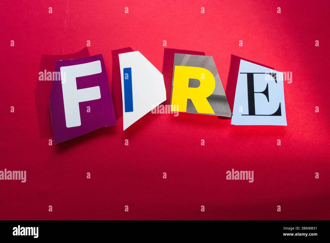 "FEUER" mit ausgeschnittenen Papierbuchstaben in der Lösegeldscheineffekt-Typografie, 2025 Stockfoto