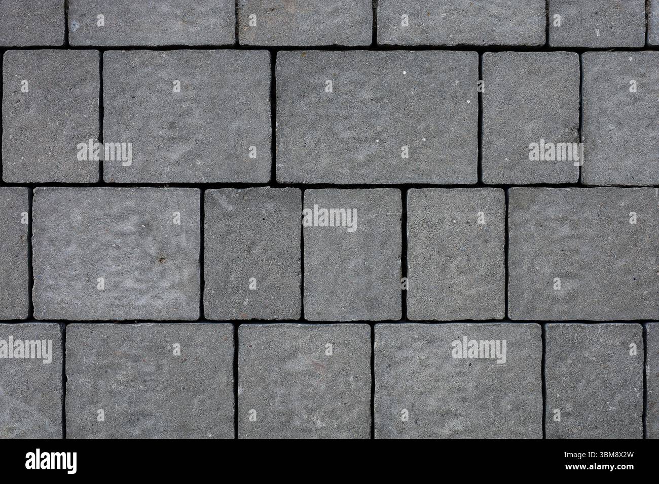 Dunkelgraue äußere Pflastersteine Nahaufnahmetextur Stockfoto
