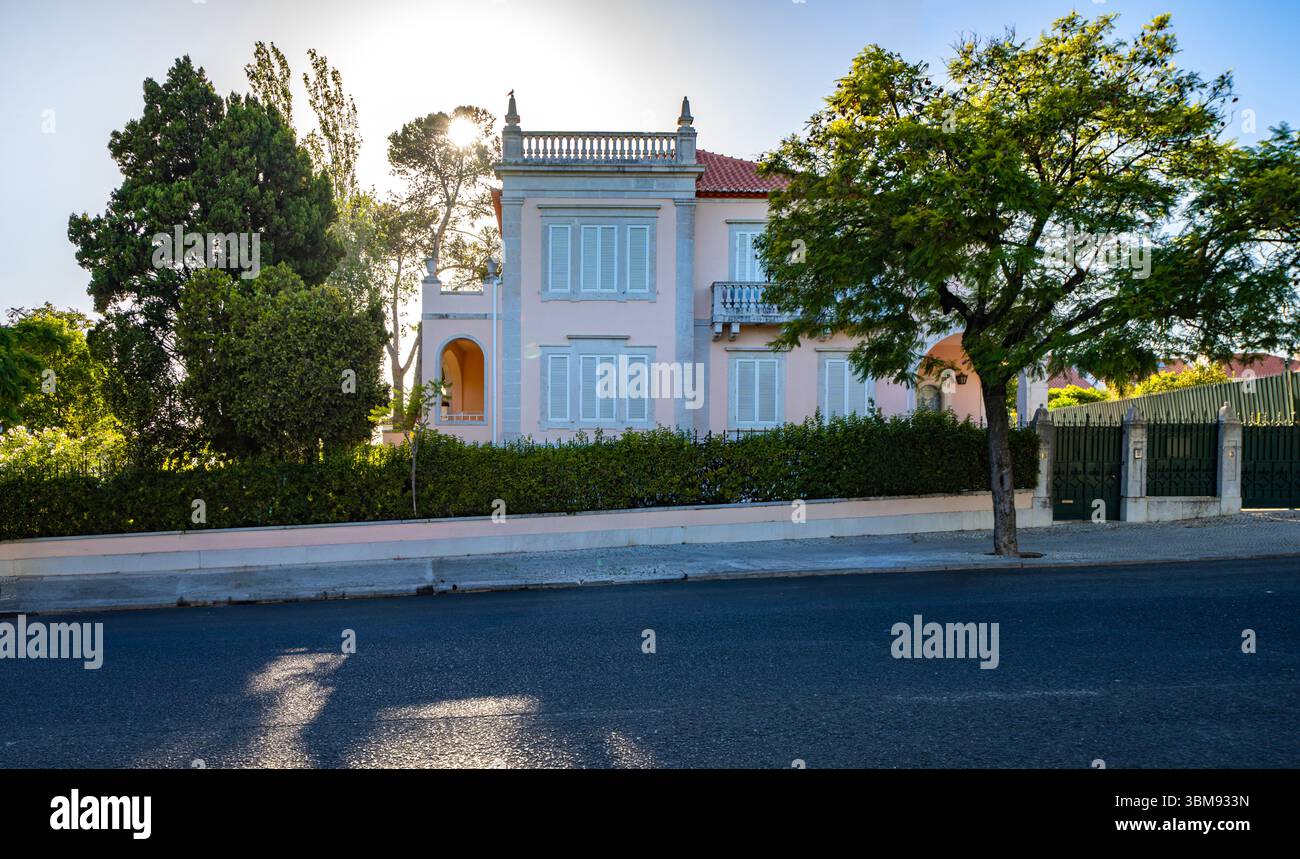 Elegante portugiesische Villa mit neoklassizistischer Fassade an der Avenida da Torre de Belém, Lissabon, mit traditionellen blauen Fensterläden und verzierten Details Stockfoto