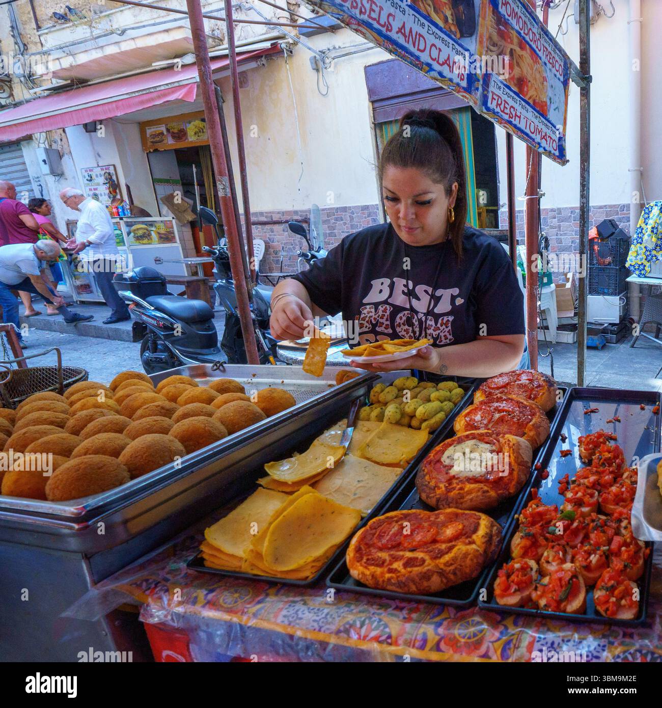 Dieses Bild fängt die lebendige und geschmackvolle Essenz des Ballarò Markts in Palermo, Sizilien, ein. Ein belebter Imbissstand serviert ikonisches sizilianisches Street Food Stockfoto