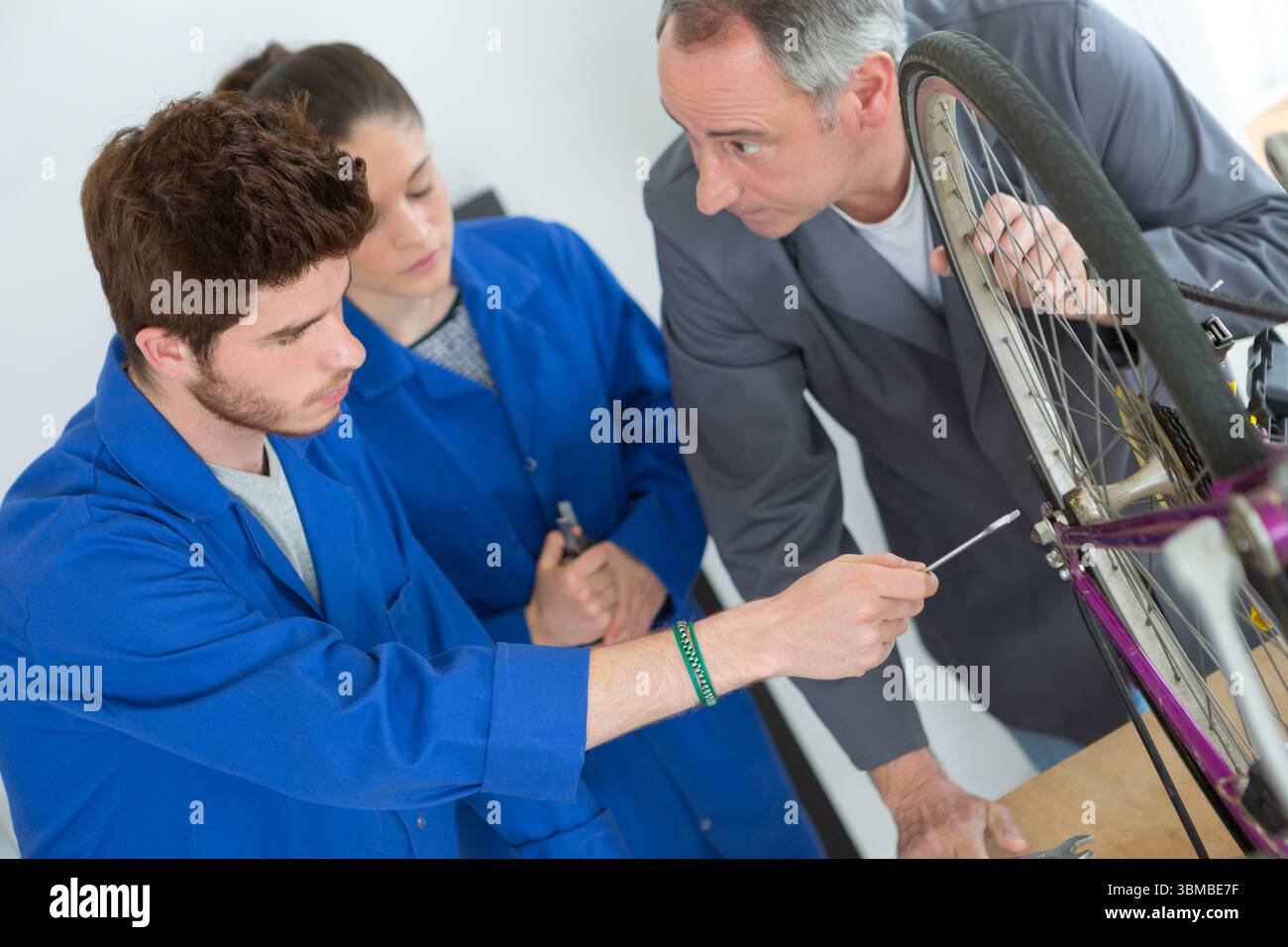 Fahrradmechaniker und Lehrling eine Fahrrad in Werkstatt Reparatur Stockfoto