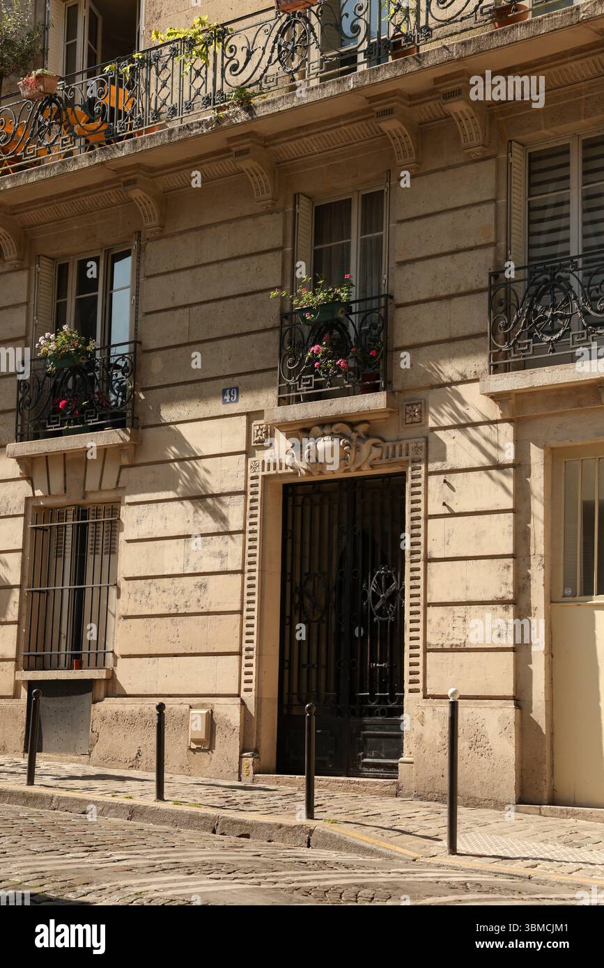 Ein sonnendurchflutetes Foto, das die elegante Fassade eines Pariser Gebäudes zeigt. Stockfoto