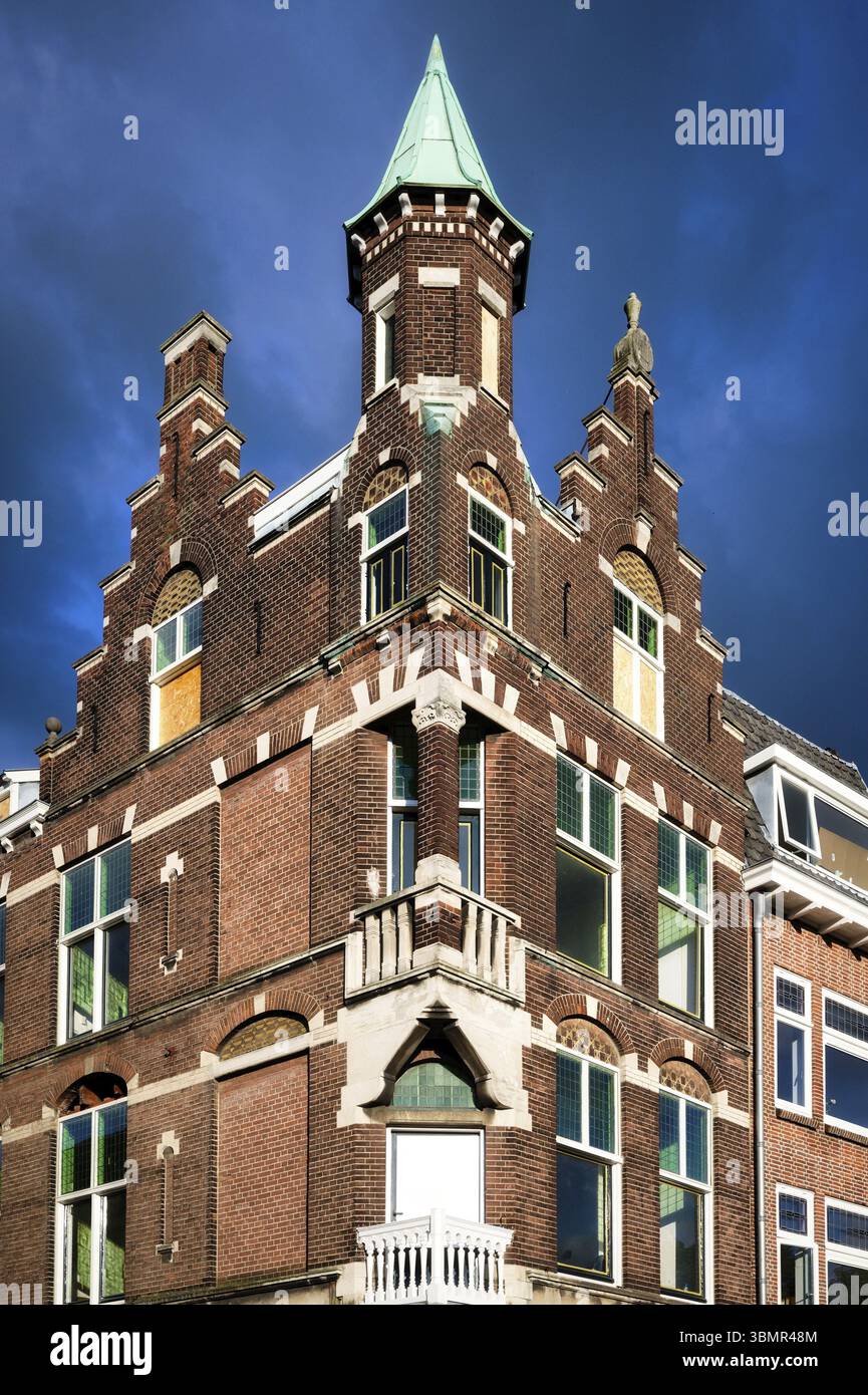 Historische, verzierte Backsteinhäuser im Stadtzentrum von utrecht in den niederlanden vor einem wolkig dunkelblauen Himmel Stockfoto