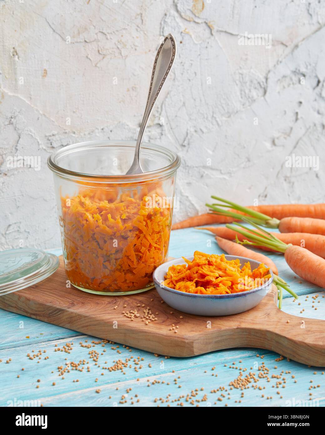 Geriebener Karottensalat in einem Glas – rohe vegane Mahlzeitenzubereitung Stockfoto