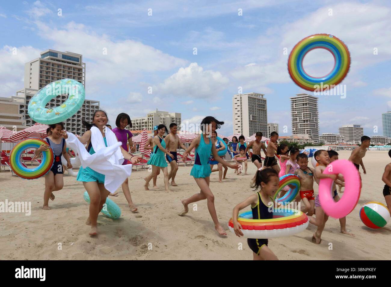 Children run into sea at the Wonsan-Kalma resort in Wonsan, Kangwon Province, North Korea, Wednesday, July 2, 2025. (AP Photo/Jon Chol Jin) Stockfoto