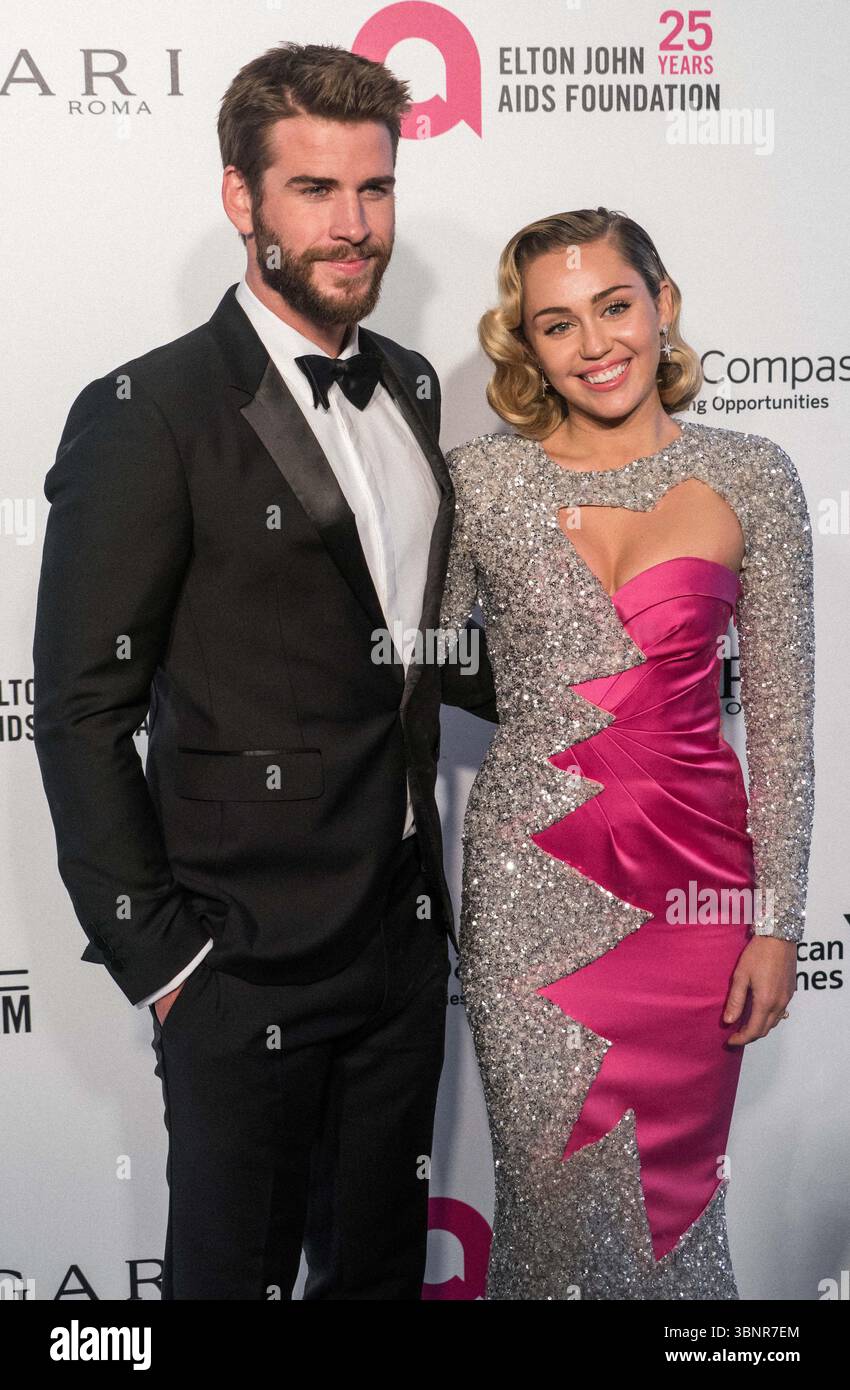 (DATEI) Miley Cyrus erhielt 2026 den Star auf dem Hollywood Walk of Fame. Miley Cyrus gehörte zu den 35 Preisträgern, die am Mittwoch, den 2. Juli 2025 von Eugenio Derbez und Richard Blade angekündigt wurden. WEST HOLLYWOOD, LOS ANGELES, KALIFORNIEN, USA - 4. MÄRZ: Der australische Schauspieler Liam Hemsworth trägt einen Burberry-Smoking und seine Freundin/amerikanische Sängerin, Songwriterin und Schauspielerin Miley Cyrus in einem doppelten rosa und funkelnden Moschino-Kleid kommen bei der 26. Jährlichen Elton John AIDS Foundation's Academy Awards Viewing Party, die am 4. März 2018 im City of West Hollywood Park in Los Angeles, Kalifornien stattfindet Stockfoto