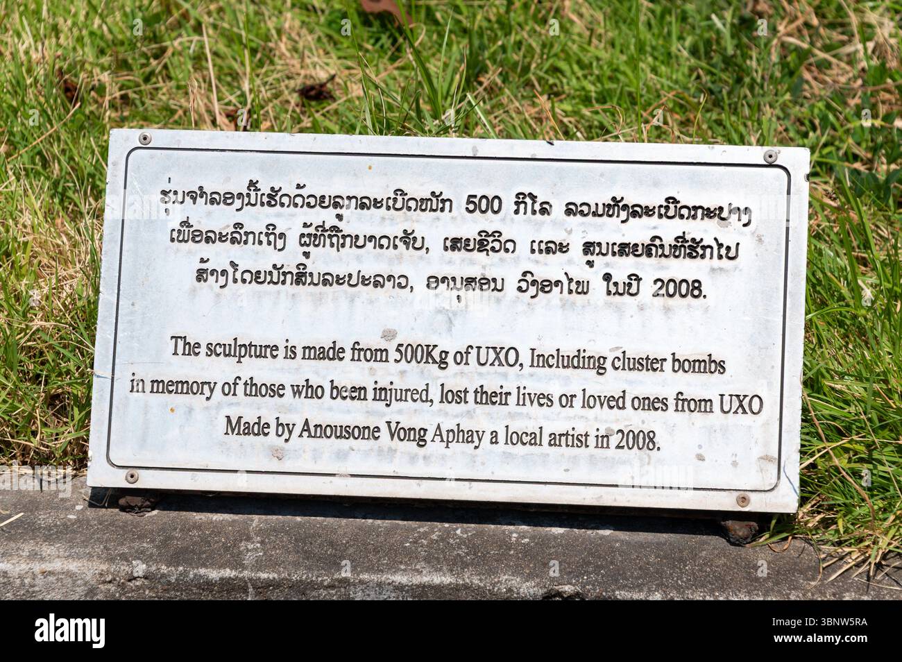 Eine Gedenktafel an einer Skulptur aus 500 kg UXO , einschließlich Streubomben von Verletzten, Toten oder Angehörigen von UXO Stockfoto