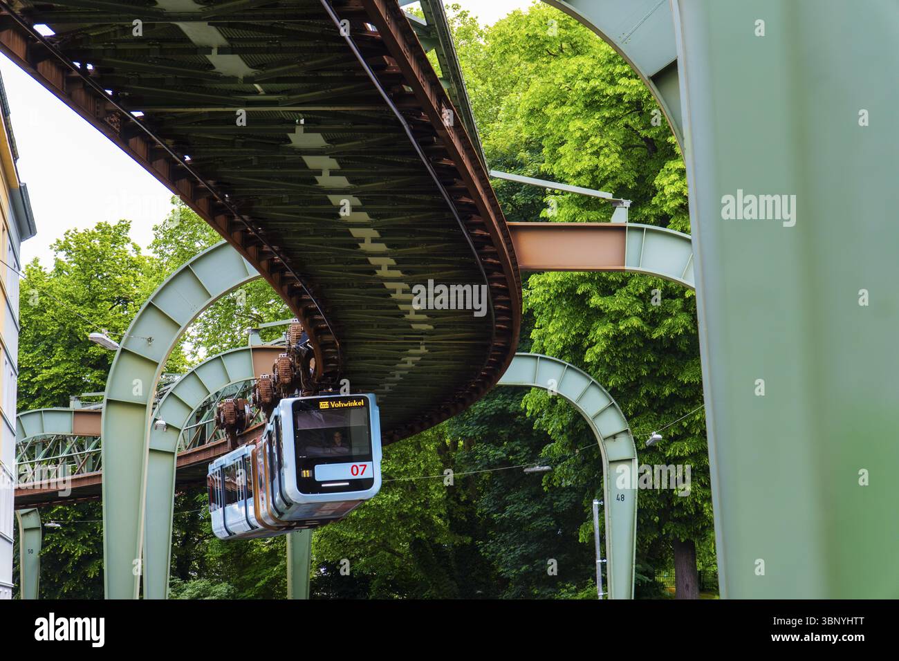 Die Wuppertaler Schwebebahn führt durch Vohwinkel vor Gebäuden aus der Gründerzeit in der Nähe der Haltestelle Hammerstein in Wuppertal Stockfoto