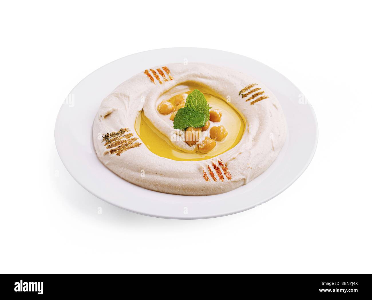 Auf einem weißen Teller wird Stillleben, cremiger Hummus serviert, garniert mit einem Spritzer Olivenöl und garniert mit Kichererbsen und einem Minzzweig. Die Stockfoto
