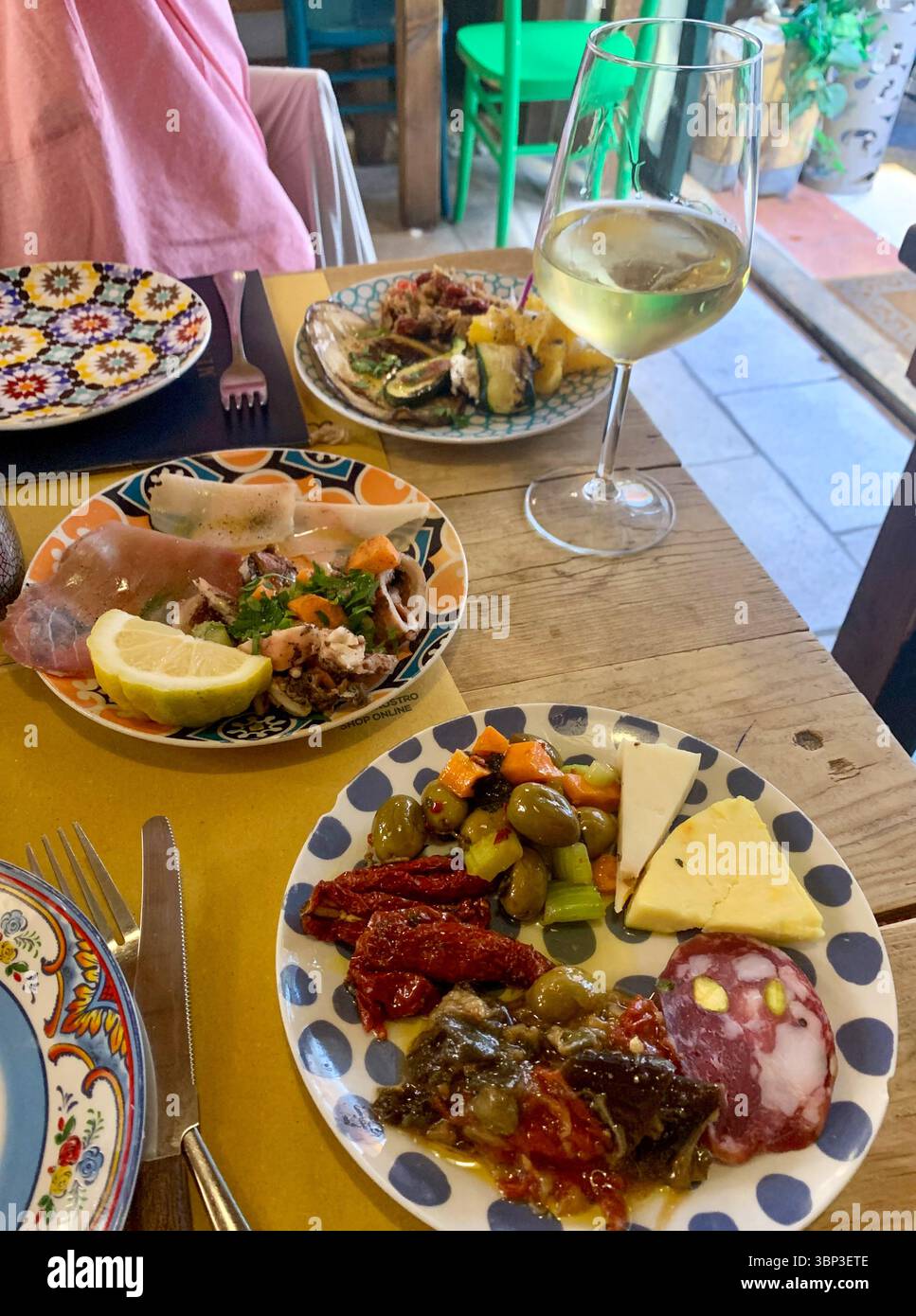 Eine lebendige Nahaufnahme der gemischten Verkostungsplatte in Einem Putia Restaurant in Ortigia - eine farbenfrohe Auswahl an sizilianischen Spezialitäten, die wunderschön serviert werden. Stockfoto