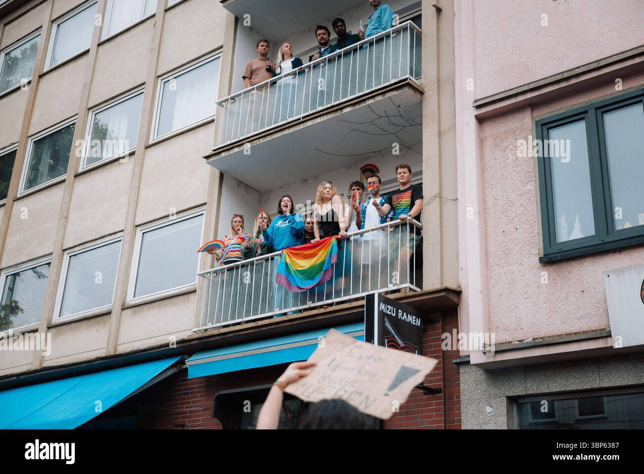 06.07.2025, CSD Köln 2025, Parade und Demonstration für Vielfalt und Gleichberechtigung Teilnehmer:innen beim CSD Köln 2025 feiern auf Balkon mit Regenbogenfächern, Flagge und erhobenen Armen in feierlicher Pose. Köln Köln NRW Deutschland *** 06 07 2025, CSD Köln 2025, Parade und Demonstration für Vielfalt und Gleichheit Teilnehmer des CSD Köln 2025 feiern auf einem Balkon mit Regenbogenfans, Flagge und erhobenen Armen in feierlicher Pose Köln Köln NRW Deutschland Stockfoto