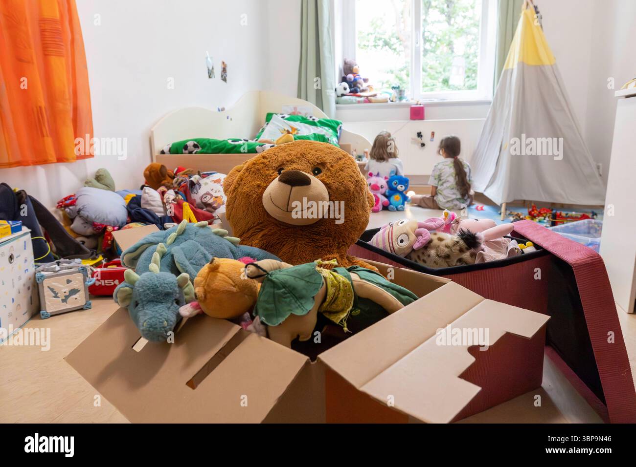 Kinder in Kinderwohngruppe zwei Mädchen sitzen auf dem Boden einer Kinderwohngruppe im sächsischen Coswig. Symbolisch steht ein Karton mit Kuscheltieren vor den Kindern. Coswig Sachsen Deutschland *** Kinder in einer Kinderwohngruppe zwei Mädchen sitzen auf dem Boden einer Kinderwohngruppe in Coswig, Sachsen, Eine Schachtel mit Kuschelspielzeug steht symbolisch vor den Kindern Coswig Sachsen Deutschland Daniel Wagner Stockfoto