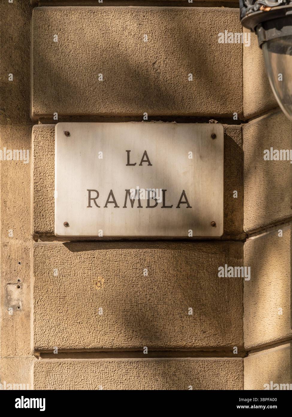 Ein klassisches Marmor-Straßenschild für „La Rambla“, den berühmten zentralen Boulevard in Barcelona, Spanien, montiert auf einer verwitterten Steinfassade. Stockfoto